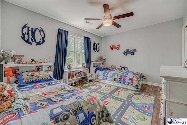 bedroom with baseboards, a ceiling fan, and wood finished floors