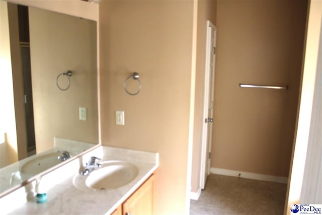 bathroom featuring vanity and baseboards