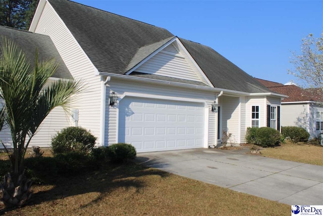 view of front of home with concrete driveway and a garage