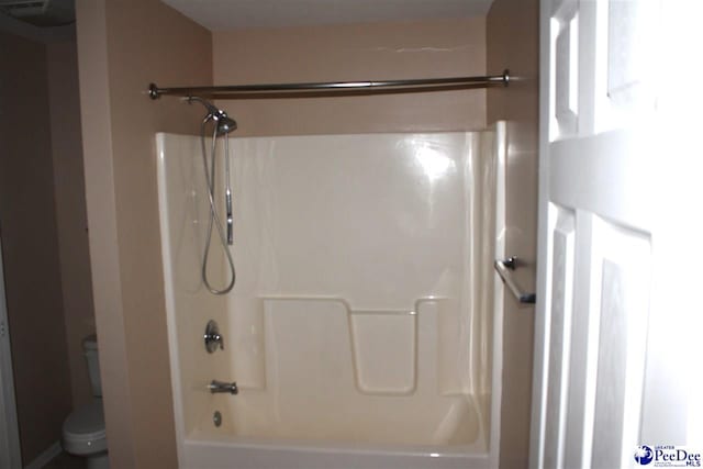 bathroom featuring toilet and shower / tub combination