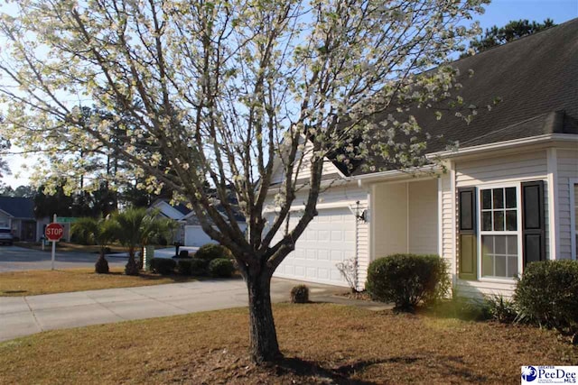 view of property exterior featuring driveway and a garage