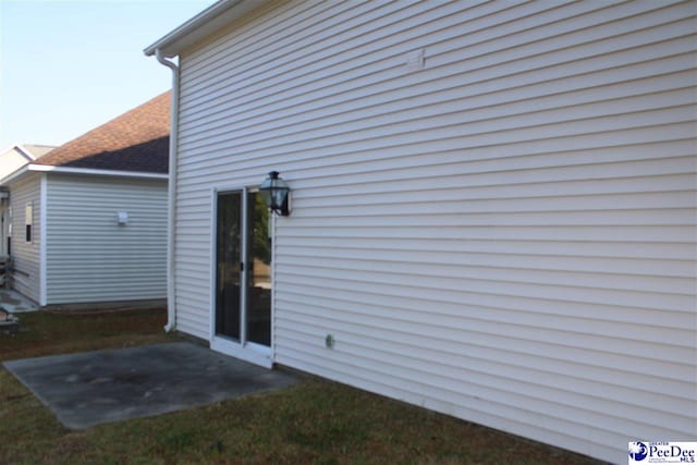 back of property featuring a shingled roof