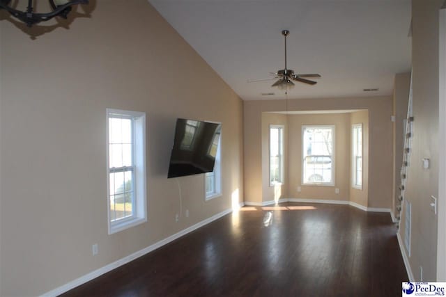 unfurnished living room featuring baseboards, wood finished floors, and a ceiling fan