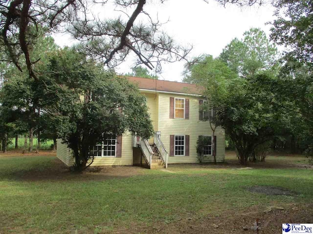 back of house featuring a yard