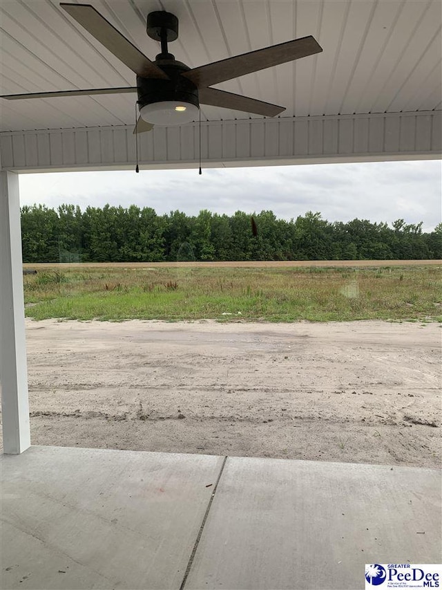 4974 E National Cemetery Rd, Florence, SC 29506 - view of patio with ceiling fan and a wooded view