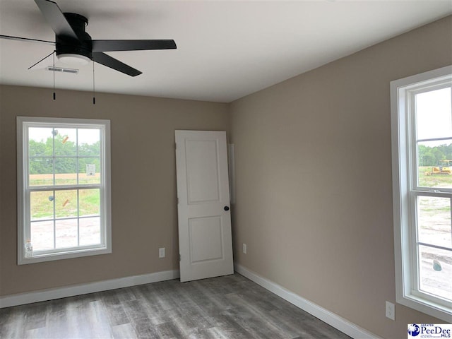 4974 E National Cemetery Rd, Florence, SC 29506 - unfurnished room featuring a ceiling fan, wood finished floors, and baseboards