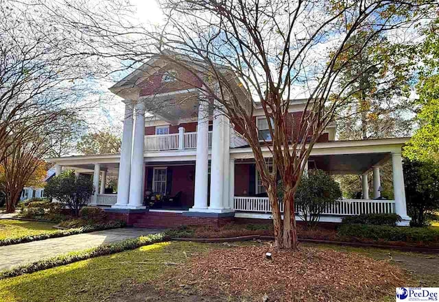 neoclassical home featuring a porch