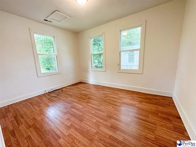 spare room featuring hardwood / wood-style flooring