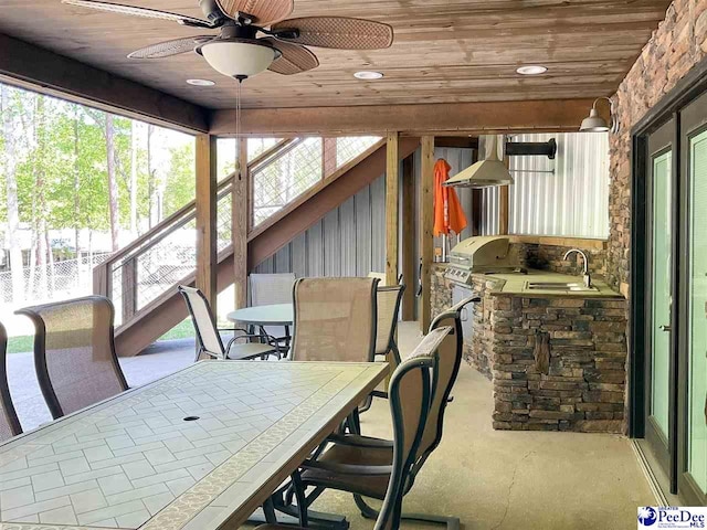 sunroom with a healthy amount of sunlight and a sink