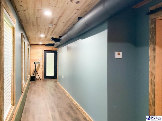 hall with recessed lighting, wooden ceiling, wood finished floors, and baseboards