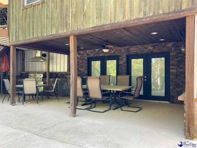 view of patio featuring french doors, outdoor dining space, and a ceiling fan