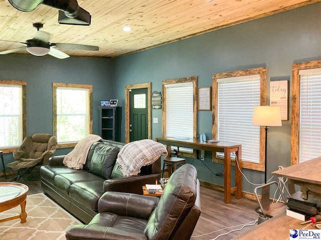 living area featuring wooden ceiling, wood finished floors, a wealth of natural light, and a ceiling fan