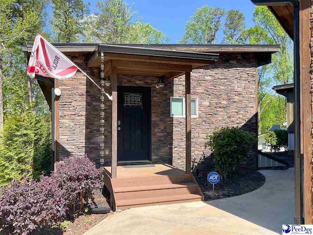 view of exterior entry with stone siding
