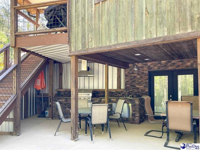 view of patio with stairway, french doors, outdoor dining space, and area for grilling