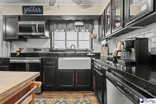 304 Wells St, Darlington, SC 29532 - kitchen featuring stainless steel appliances, a sink, dark cabinetry, backsplash, and crown molding