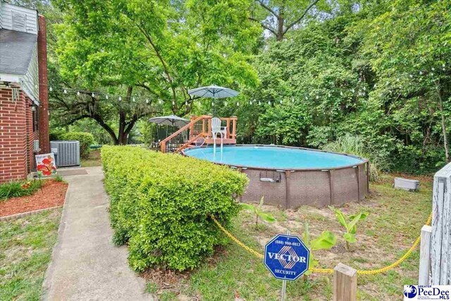 304 Wells St, Darlington, SC 29532 - swimming pool with cooling unit and view of wooded area