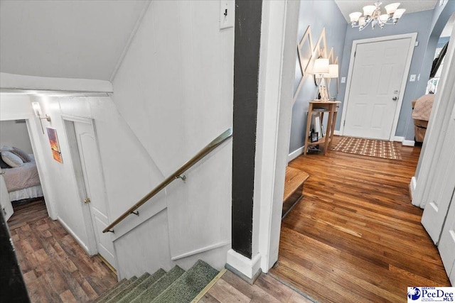 304 Wells St, Darlington, SC 29532 - stairs featuring a chandelier, wood finished floors, and baseboards
