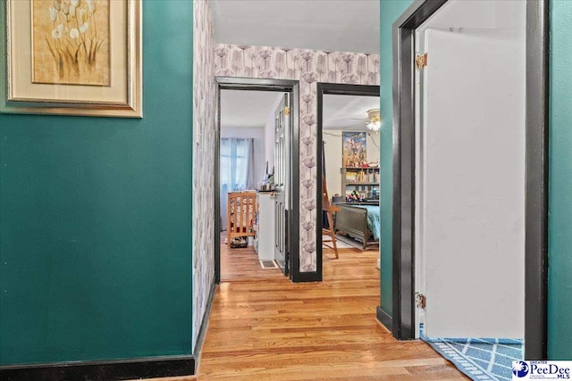 304 Wells St, Darlington, SC 29532 - corridor featuring wallpapered walls, light wood-style flooring, and baseboards