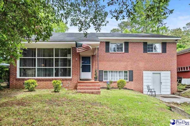 304 Wells St, Darlington, SC 29532 - view of front of property featuring a front yard, brick siding, and entry steps