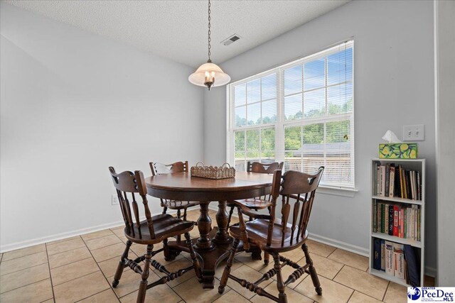 657 Red Tip Cir, Florence, SC 29501 - dining room featuring a textured ceiling, light tile patterned floors, and baseboards