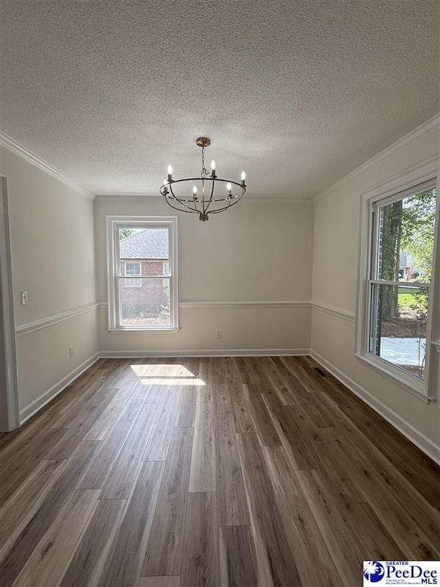 418 S Thomas Rd, Florence, SC 29501 - unfurnished dining area featuring healthy amount of natural light, a chandelier, crown molding, a textured ceiling, and dark wood finished floors