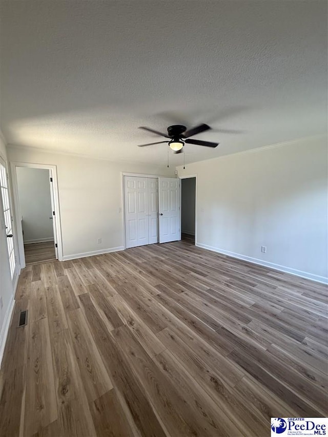 418 S Thomas Rd, Florence, SC 29501 - unfurnished living room with a ceiling fan, wood finished floors, a textured ceiling, and baseboards