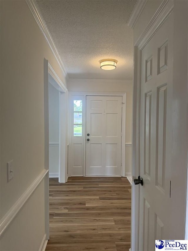 418 S Thomas Rd, Florence, SC 29501 - doorway with a textured ceiling, wood finished floors, and ornamental molding