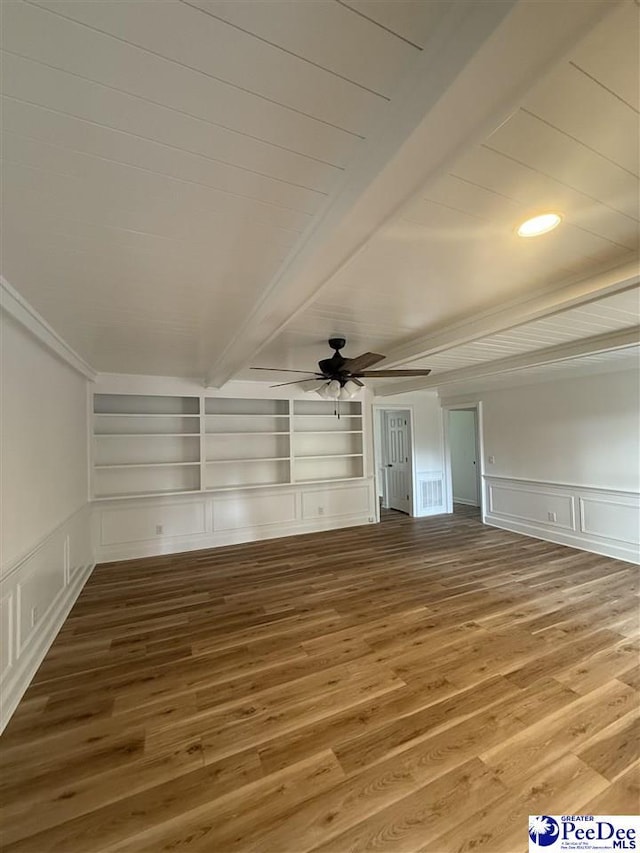 418 S Thomas Rd, Florence, SC 29501 - unfurnished living room featuring a decorative wall, wood finished floors, a ceiling fan, beam ceiling, and built in shelves