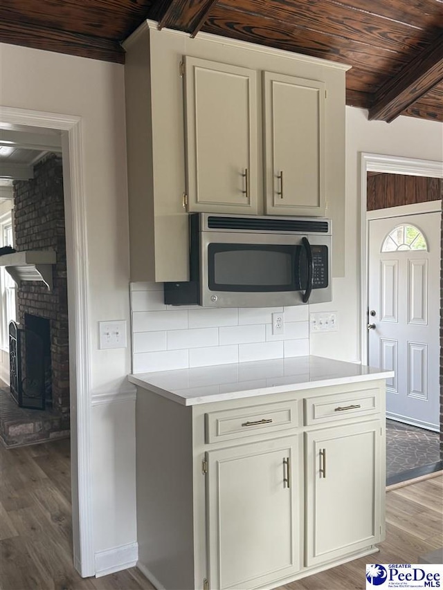 418 S Thomas Rd, Florence, SC 29501 - kitchen featuring stainless steel microwave, wooden ceiling, wood finished floors, light countertops, and plenty of natural light