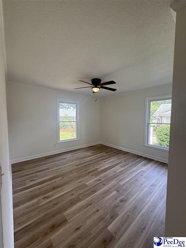 418 S Thomas Rd, Florence, SC 29501 - spare room with a textured ceiling, dark wood-style flooring, baseboards, and ceiling fan