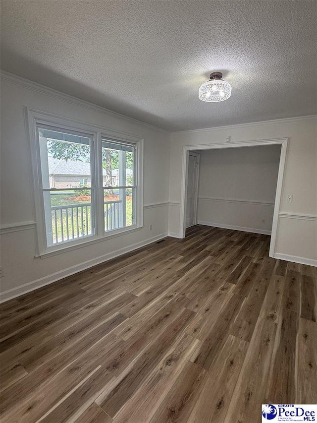 418 S Thomas Rd, Florence, SC 29501 - spare room featuring a textured ceiling, wood finished floors, ornamental molding, and baseboards