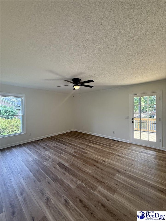 418 S Thomas Rd, Florence, SC 29501 - spare room with a textured ceiling, dark wood finished floors, a ceiling fan, and baseboards