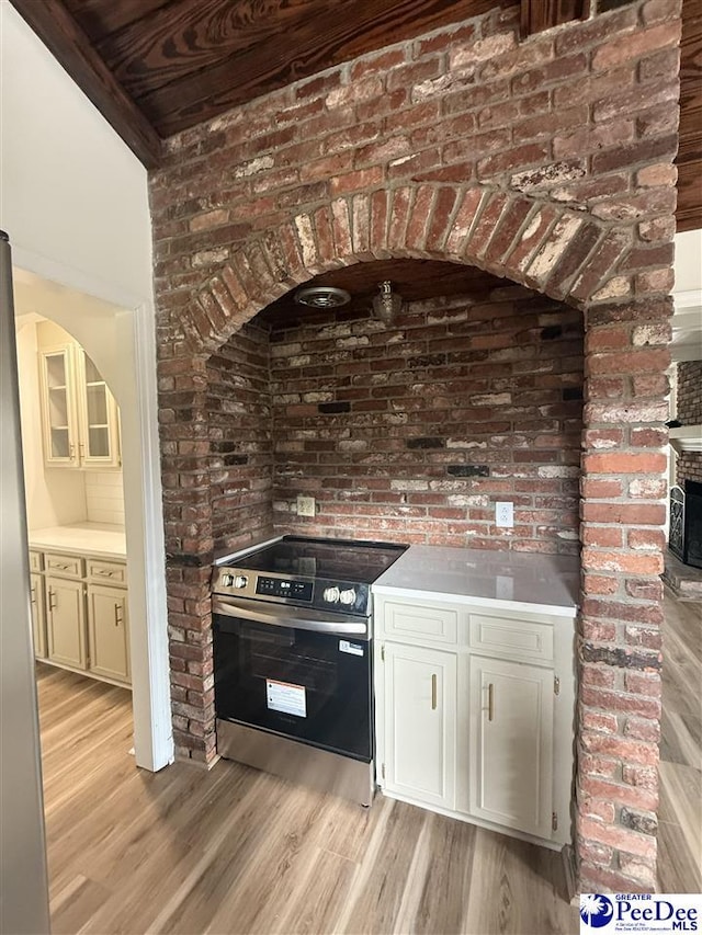 418 S Thomas Rd, Florence, SC 29501 - kitchen with stainless steel appliances, light wood-style floors, light countertops, wooden ceiling, and brick wall
