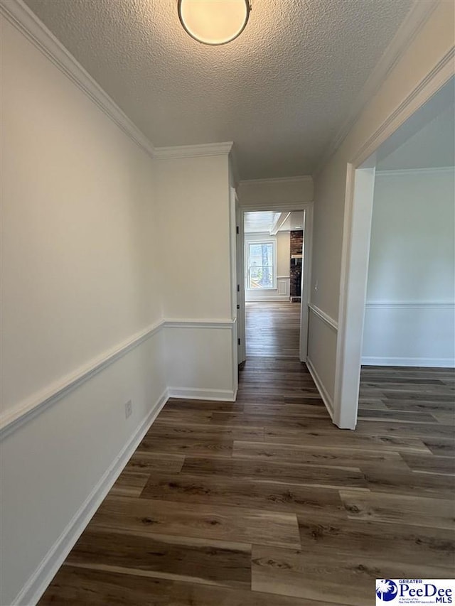 418 S Thomas Rd, Florence, SC 29501 - hallway featuring a textured ceiling, dark wood finished floors, ornamental molding, and baseboards