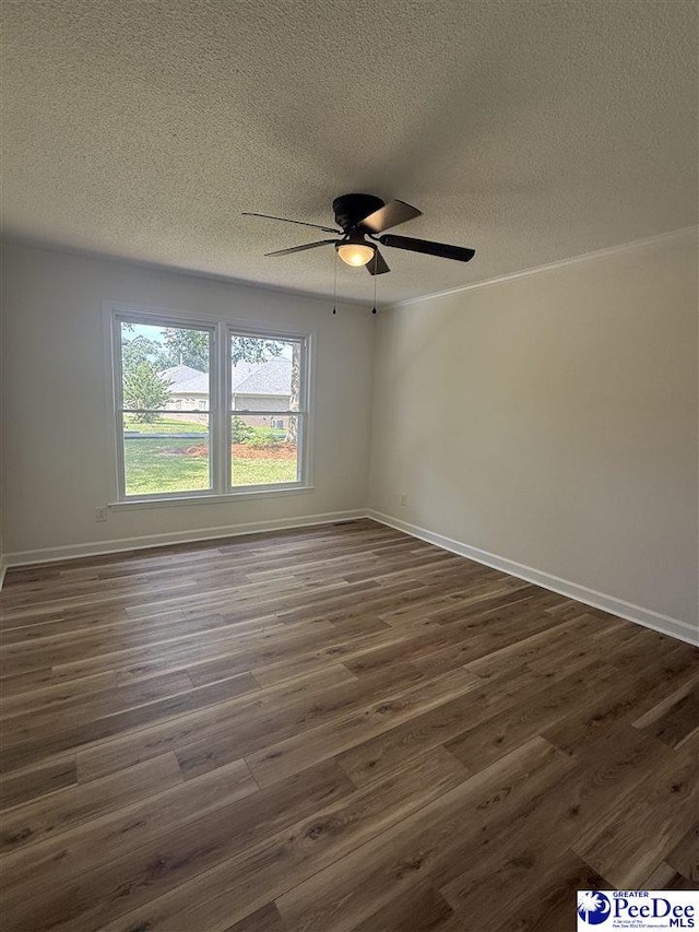 418 S Thomas Rd, Florence, SC 29501 - spare room featuring a textured ceiling, dark wood-style flooring, ceiling fan, and baseboards