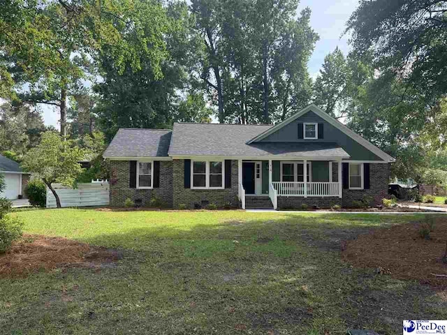 418 S Thomas Rd, Florence, SC 29501 - view of front facade featuring covered porch, a front yard, and brick siding