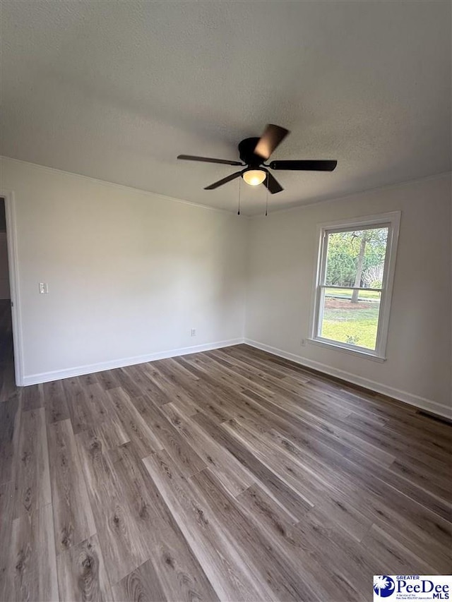 418 S Thomas Rd, Florence, SC 29501 - empty room featuring dark wood finished floors, a ceiling fan, a textured ceiling, and baseboards