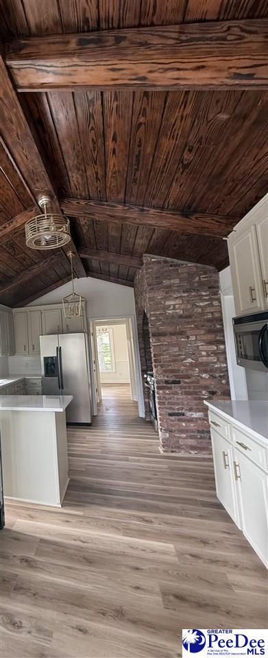418 S Thomas Rd, Florence, SC 29501 - kitchen with stainless steel refrigerator with ice dispenser, wood ceiling, white cabinetry, light wood-style flooring, and light countertops
