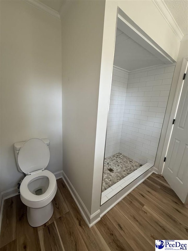 418 S Thomas Rd, Florence, SC 29501 - bathroom featuring ornamental molding, a shower stall, wood finished floors, toilet, and baseboards