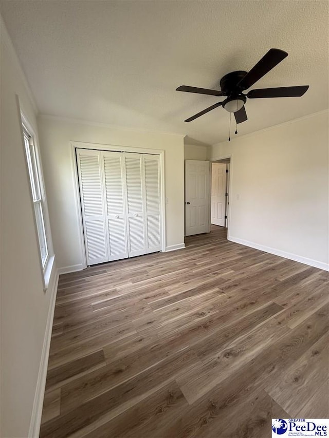 418 S Thomas Rd, Florence, SC 29501 - unfurnished bedroom featuring wood finished floors, baseboards, and a closet