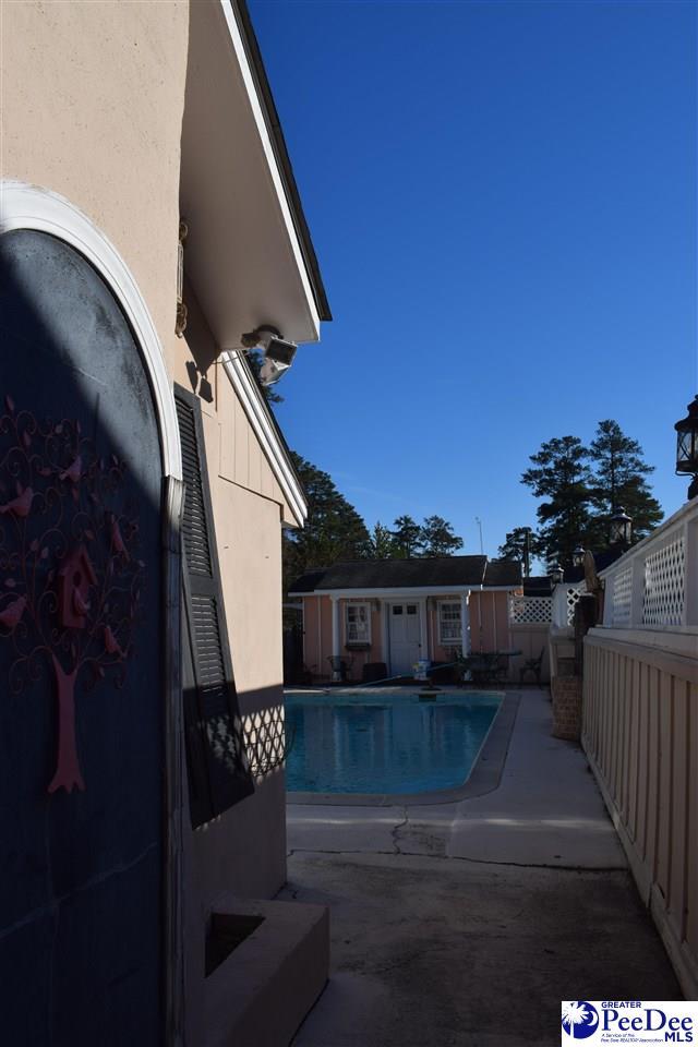 view of pool with a fenced in pool, a patio area, an outdoor structure, and fence