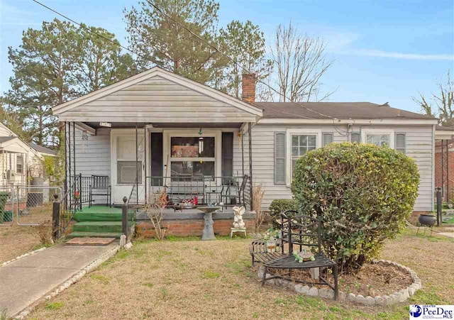 view of front facade with a porch and a front yard