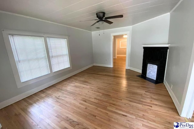 unfurnished living room featuring crown molding, ceiling fan, and light hardwood / wood-style flooring