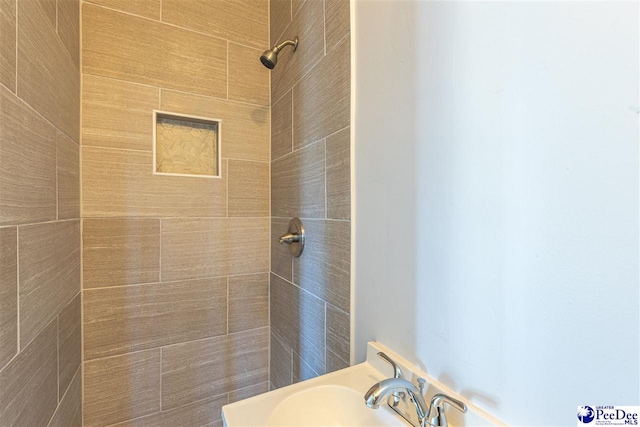 bathroom with tiled shower