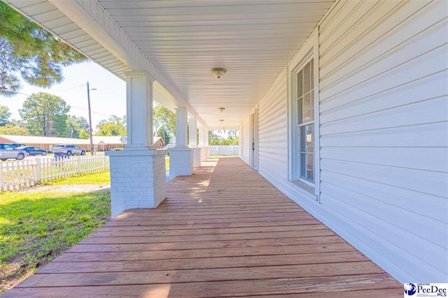 wooden terrace with a porch and fence