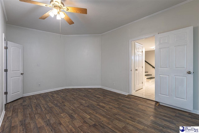 unfurnished room with stairway, baseboards, dark wood finished floors, ceiling fan, and ornamental molding