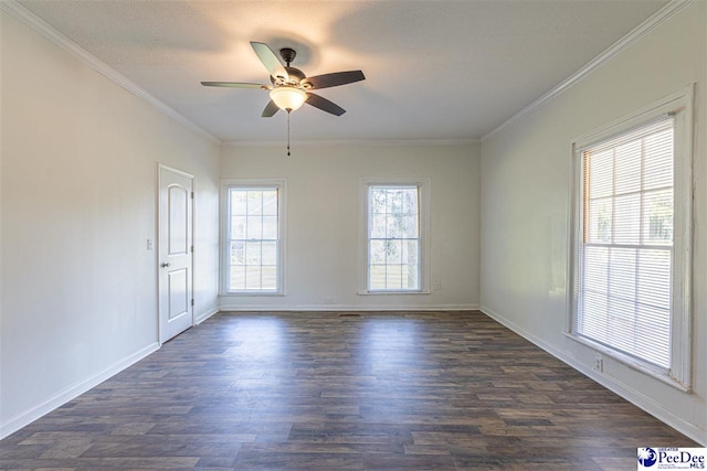 spare room featuring ornamental molding, a textured ceiling, dark wood-style floors, baseboards, and ceiling fan