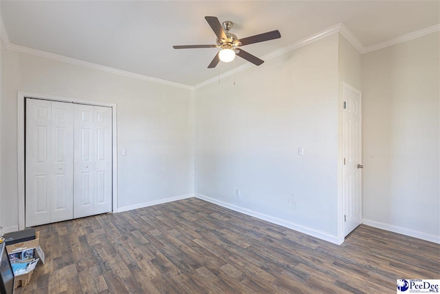 unfurnished bedroom featuring ornamental molding, ceiling fan, baseboards, and wood finished floors