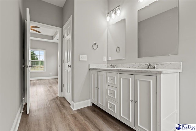 5301 Meadow Prong Rd, Effingham, SC 29541 - full bathroom with wood finished floors, double vanity, and baseboards
