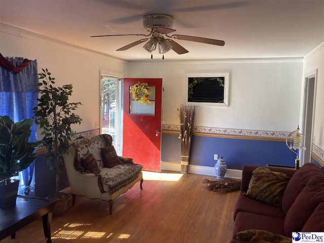 living room featuring ornamental molding, hardwood / wood-style floors, and ceiling fan